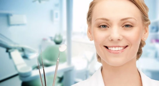 a photo of a dentist with an instrument