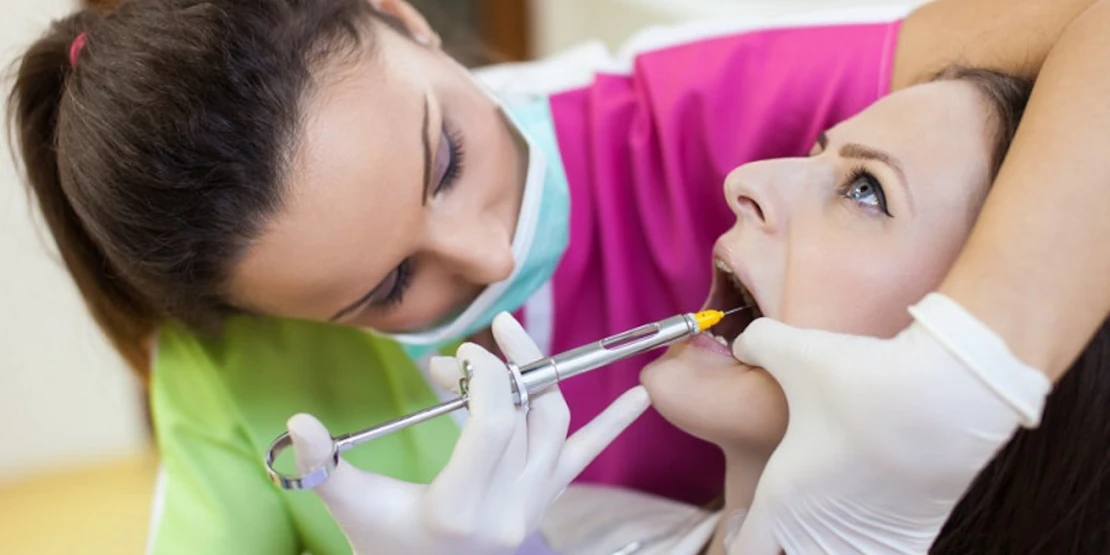 in the photo, the girl is getting an injection to anesthetize the area where the implant will be inserted